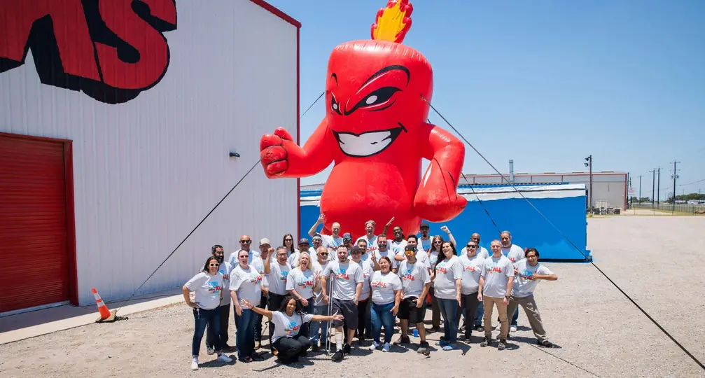 The Alamo Fireworks team posing with the giant inflatable Burst mascot